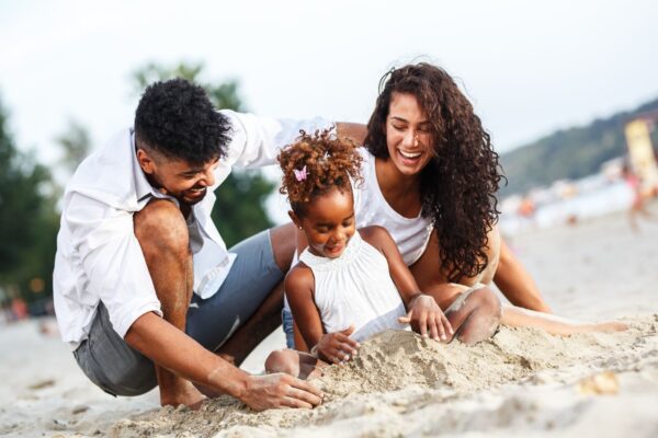 family playing with sand